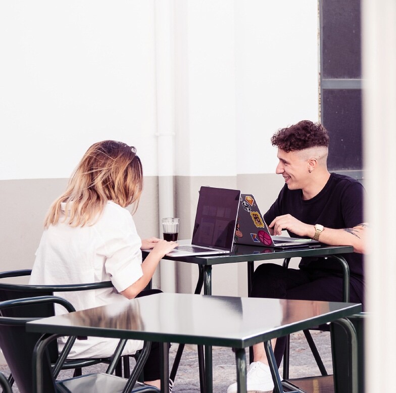 picture of two coworkers sitting at one table